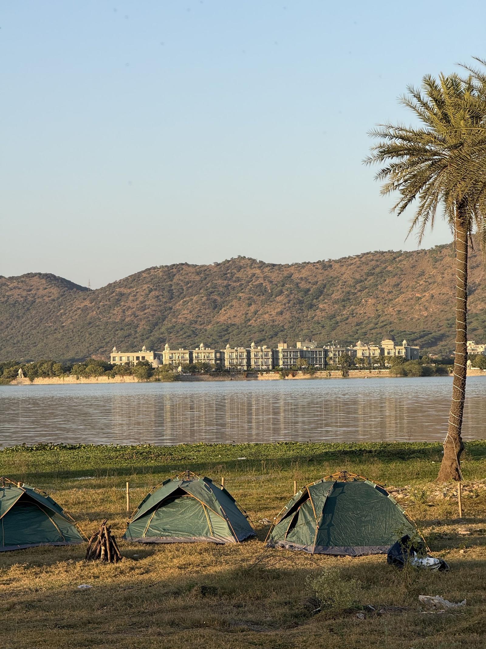 Lakeside camping at golden hour at The Udaisarovar, Udaipur