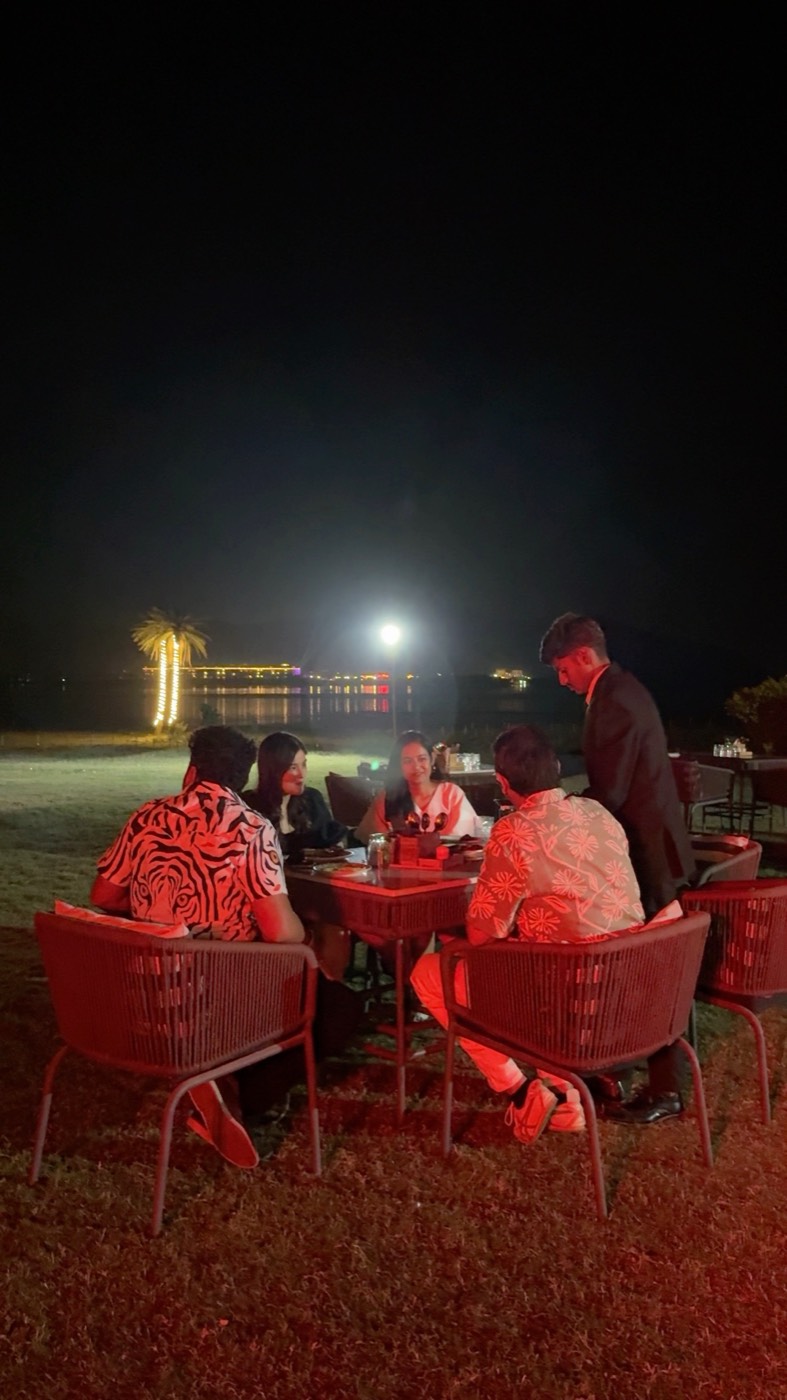 Open-air dinner by the lake at night